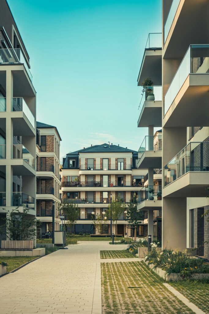 Contemporary cityscape featuring luxury apartments with balconies and outdoor pathways.